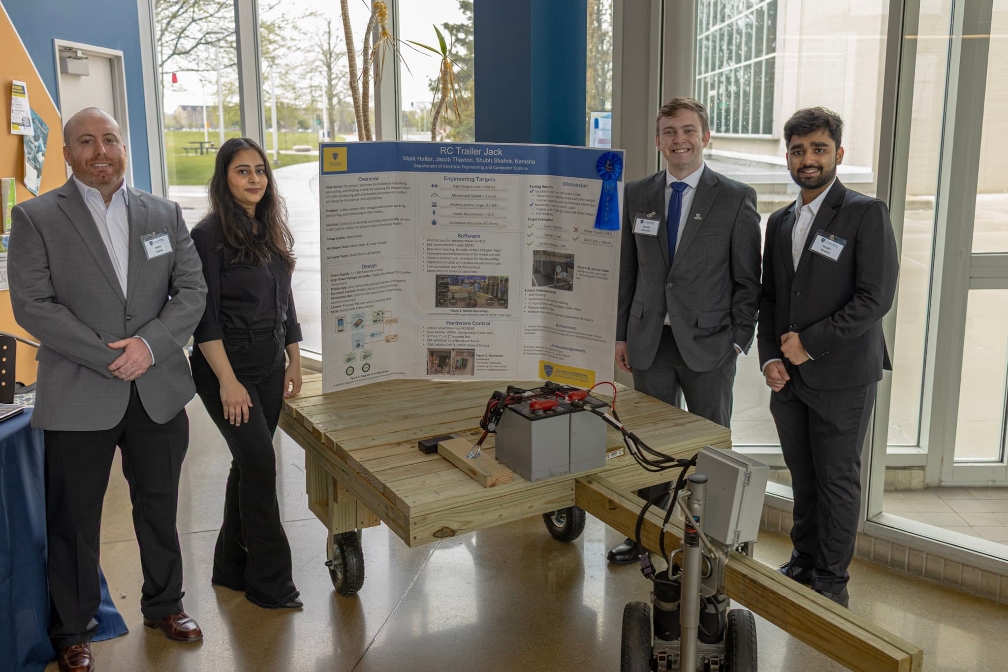 RC Trailer Jack team with the senior design poster and working prototype.